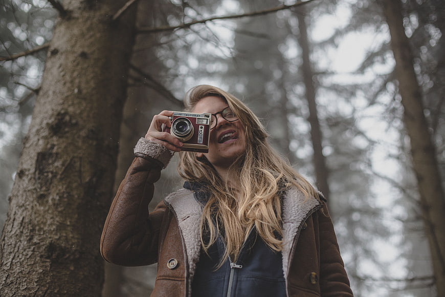Woman with Vintage Camera in Forest