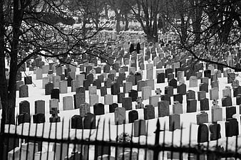 Black and white winter cemetery with snow-covered tombstones
