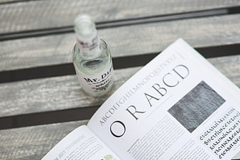 Typography book and clear bottle on wooden table