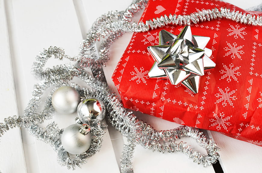 Red Christmas Gift with Silver Bow and Tinsel