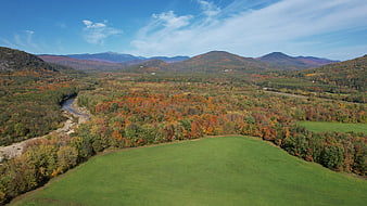 Aerial View of Autumn Forest and River Valley with Mountains