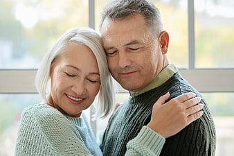 Senior couple embracing affectionately indoors