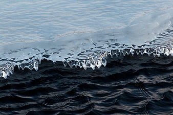 Frozen Ice Edge on Dark Water Surface