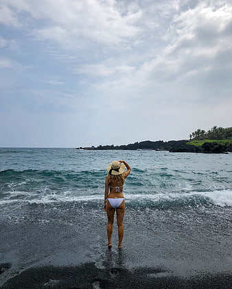 Woman in White Bikini Standing on Black Sand Beach