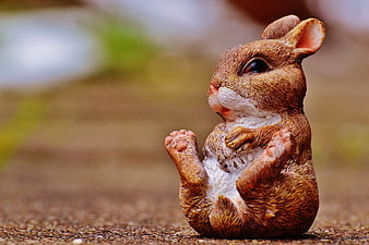 Cute Brown Rabbit Figurine Sitting on Ground