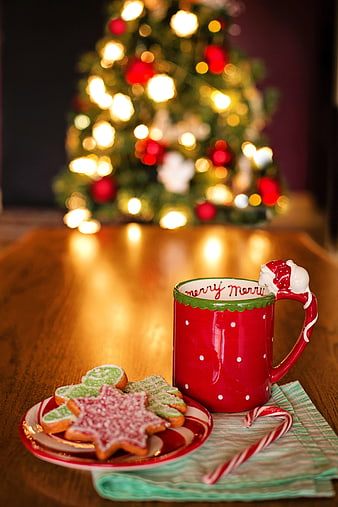 Festive Christmas Cookies and Mug with Blurred Tree Background