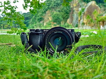 Black Sony Camera with Zeiss Lens on Green Grass