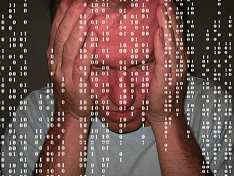Stressed Man Holding Head with Binary Code Overlay