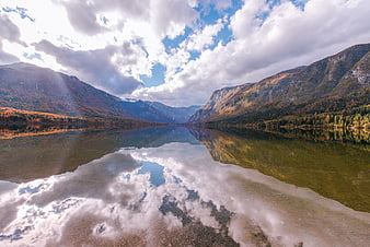 Serene Mountain Lake with Cloud Reflections in Autumn