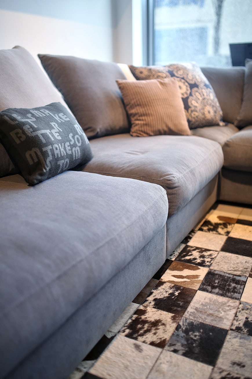 Modern grey sectional sofa with cowhide rug