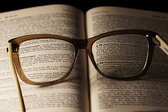 Reading glasses resting on open legal book pages