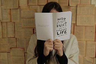 Woman Reading Inspirational Quote in Book