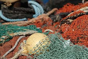 Close-up of colorful fishing nets and buoy on a boat