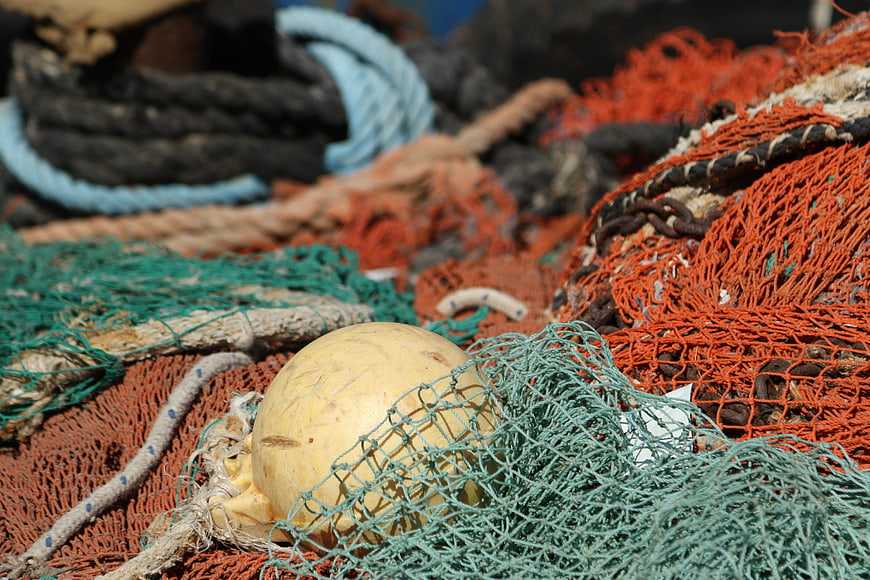 Close-up of colorful fishing nets and buoy on a boat