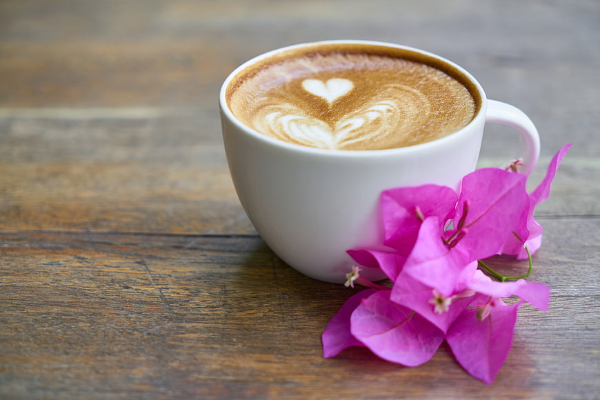 White Coffee Cup with Latte Art and Pink Bougainvillea Flowers