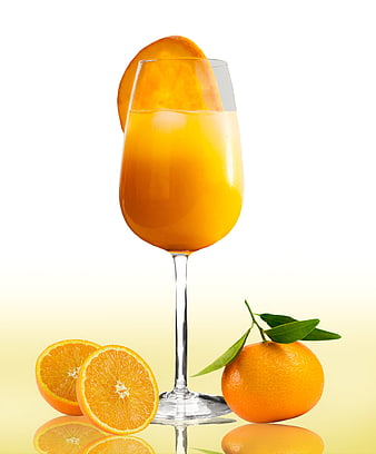 Fresh Orange Juice in Glass with Whole and Sliced Oranges