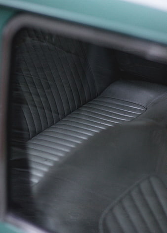 Close-up of vintage car interior with ribbed leather seats