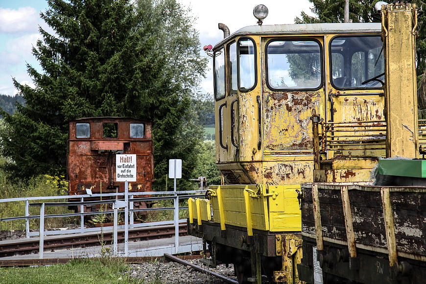 Rusty yellow and red old locomotives on railway tracks