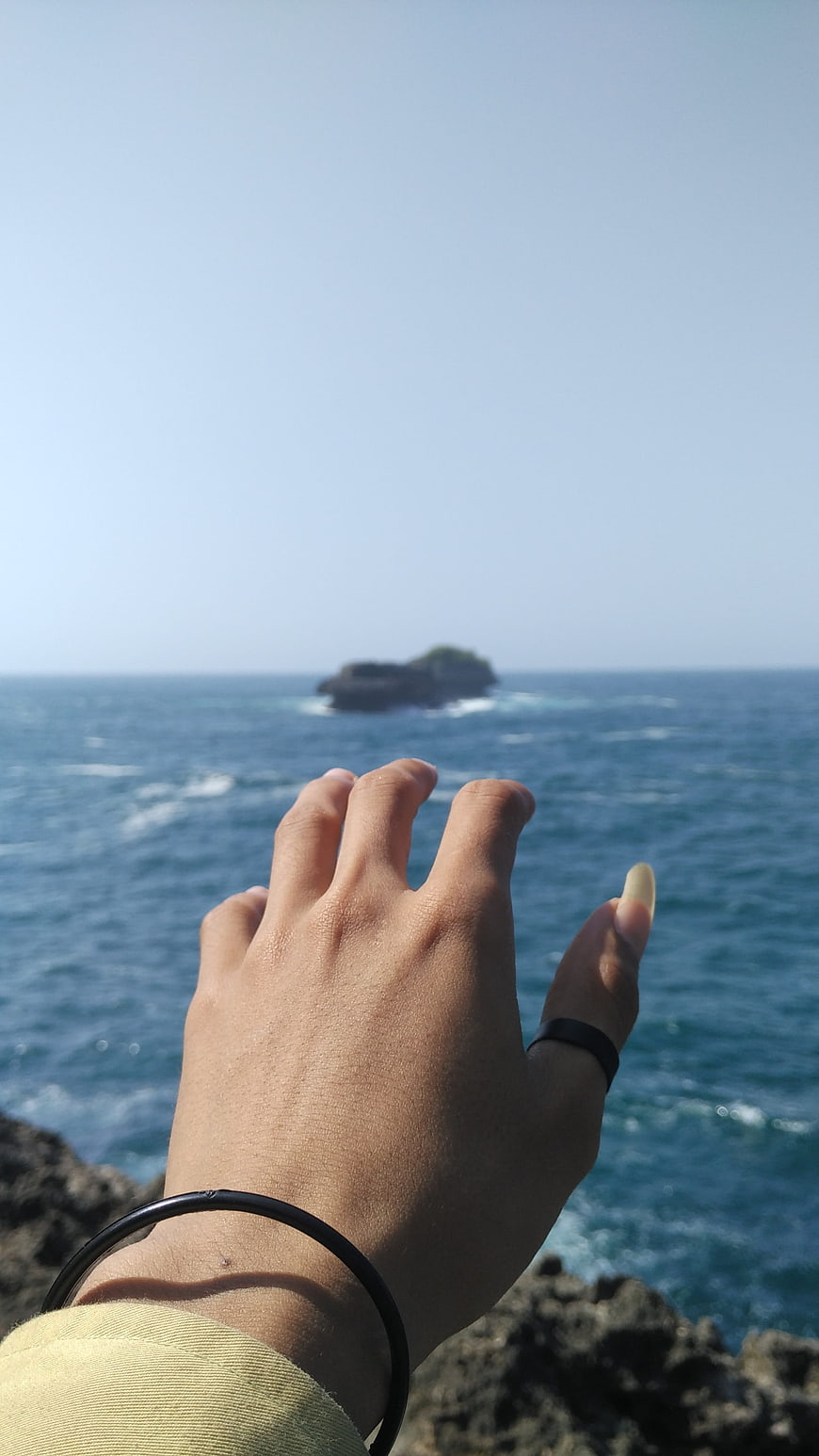 Hand Reaching Out to Ocean Island View