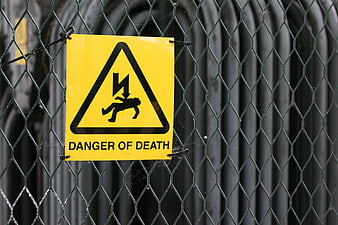 Yellow Danger of Death Warning Sign on Chain Link Fence