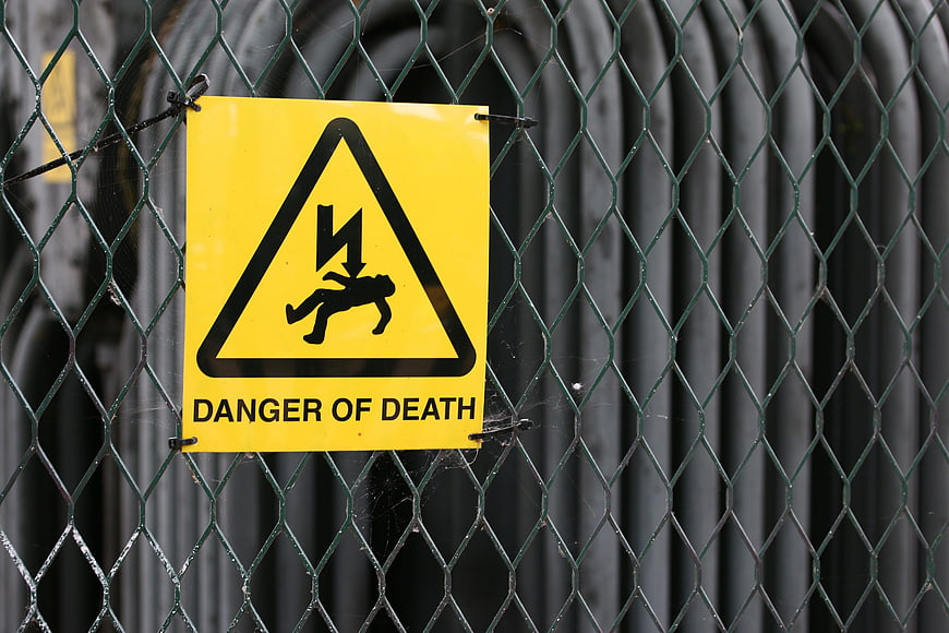 Yellow Danger of Death Warning Sign on Chain Link Fence
