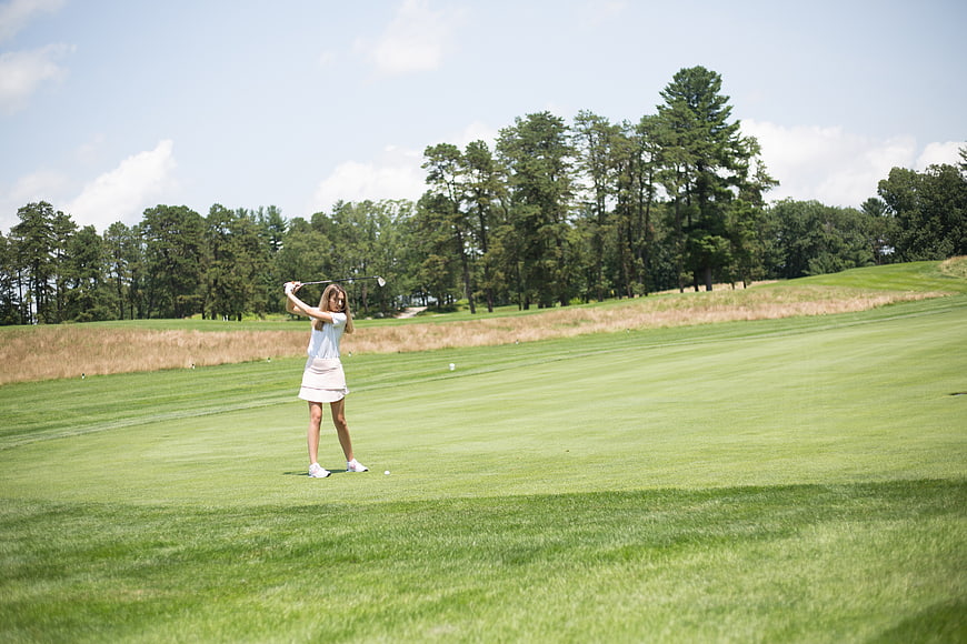 Woman Golfing on Green Course