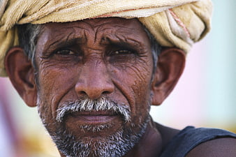 Close-up portrait of elderly Indian man with turban