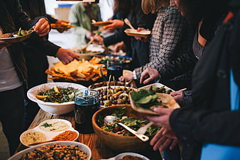 People serving themselves at a healthy buffet table
