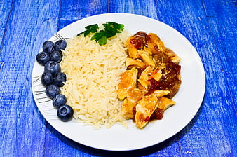 Healthy Chicken Rice and Blueberries on Blue Table