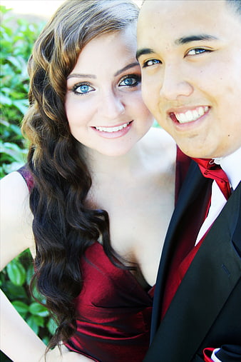 Smiling Young Couple in Formal Red and Black Attire