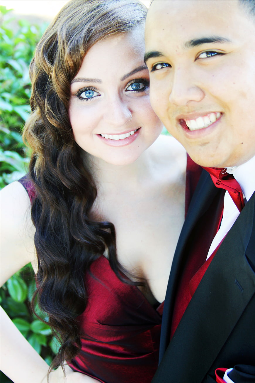 Smiling Young Couple in Formal Red and Black Attire