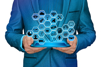 Businessman holding tablet with Industry 4.0 technology icons