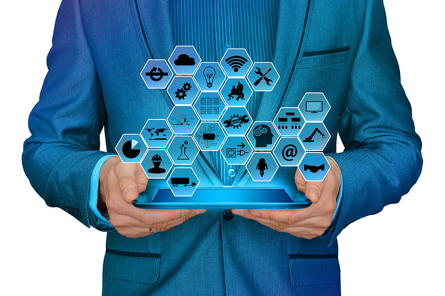 Businessman holding tablet with Industry 4.0 technology icons