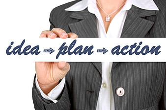 Businesswoman holding sign with idea plan action text