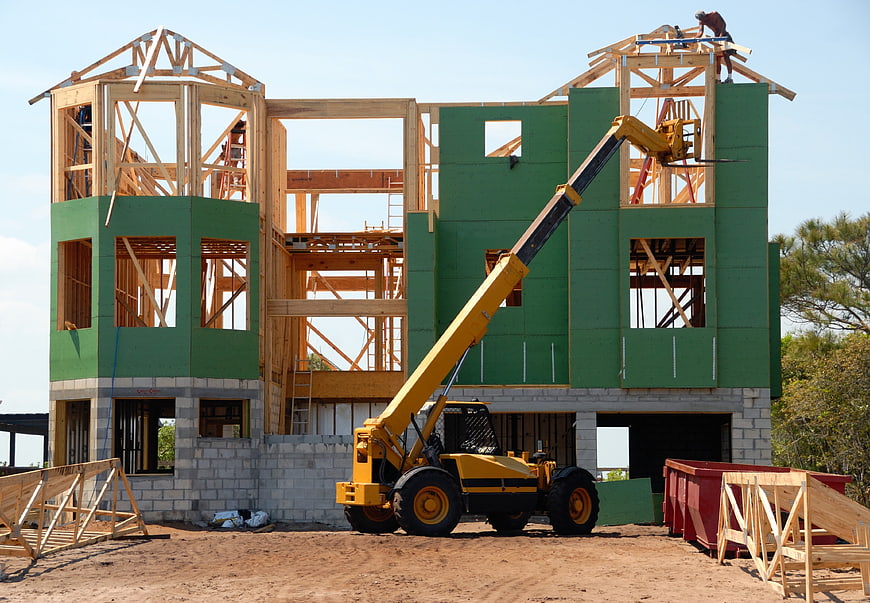 House Framing Construction with Telehandler and Workers
