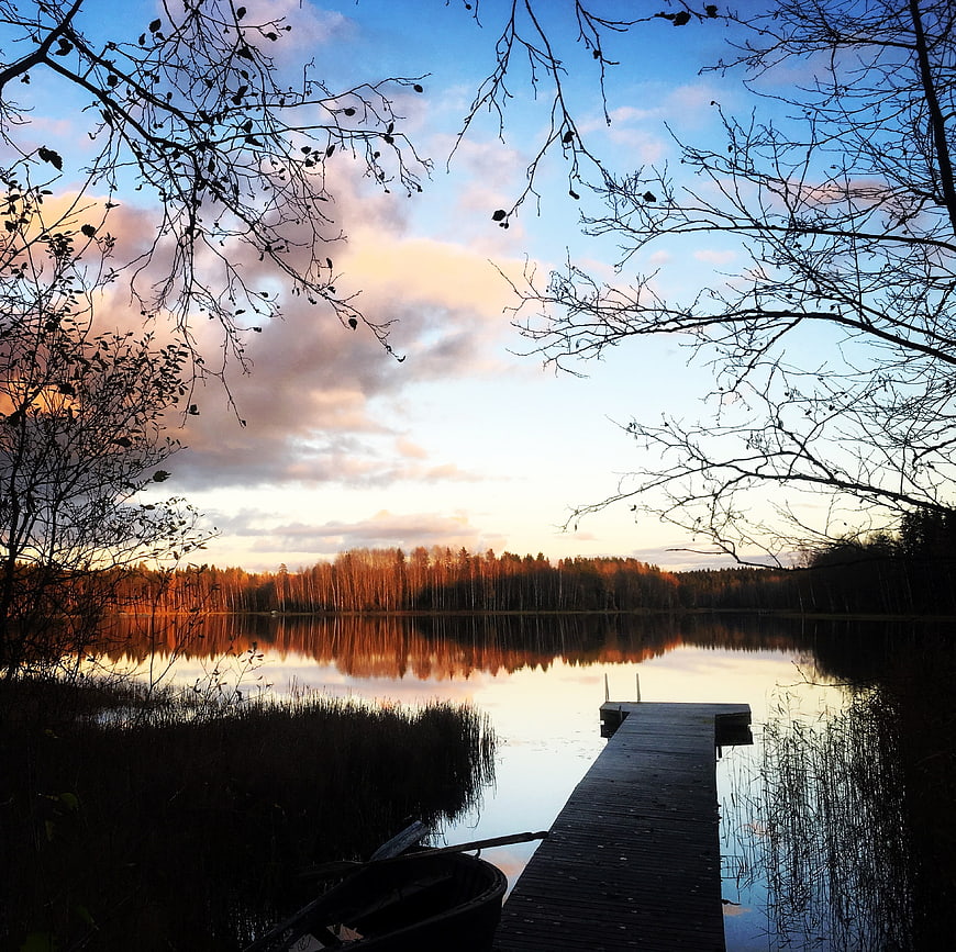 Serene Lake Sunset with Wooden Pier and Autumn Trees