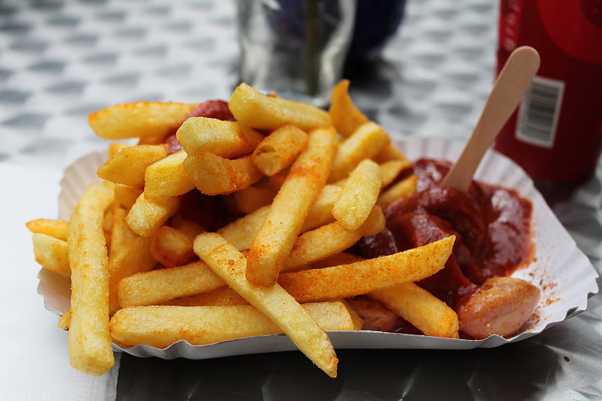 Currywurst With French Fries And Ketchup In Paper Tray