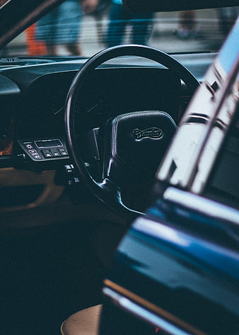 Vintage Daimler car interior with steering wheel and dashboard