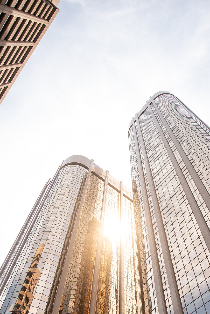 Low angle view of modern glass skyscrapers reflecting sunlight