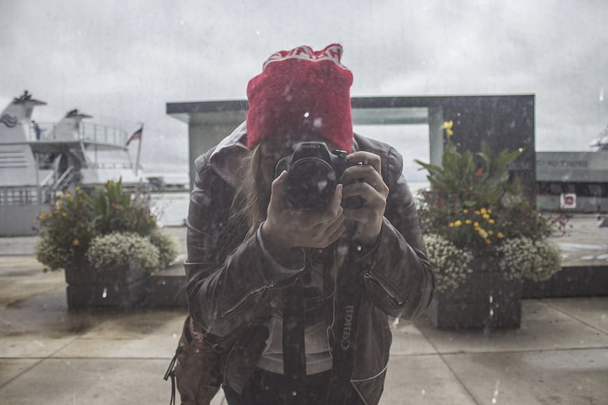 Woman Photographer Taking Mirror Selfie in Rain