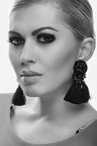 Black and White Portrait of Woman Wearing Tassel Earrings