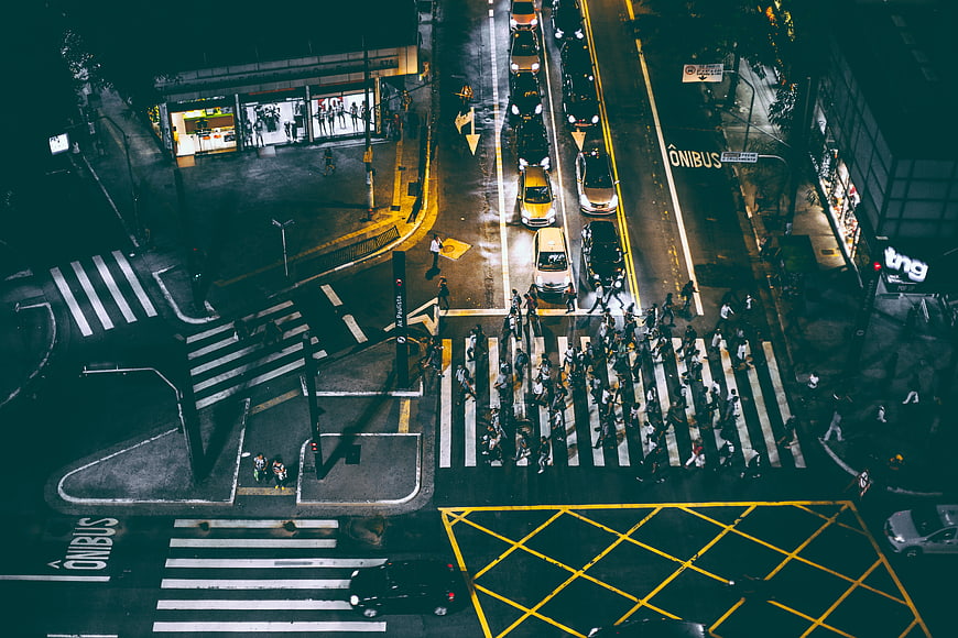 Aerial Night View of Busy Urban Intersection with Pedestrians