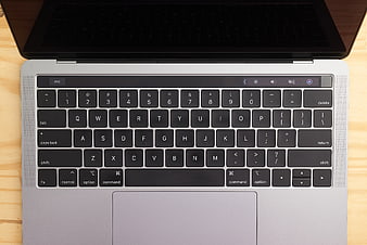 Top View of Silver Laptop Keyboard on Wooden Desk