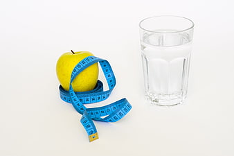 Yellow Apple with Blue Tape Measure and Glass of Water