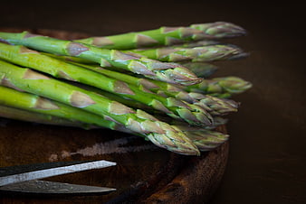 Fresh Green Asparagus on Wooden Board with Knife