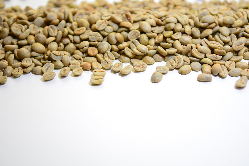 Green Coffee Beans Scattered On White Background