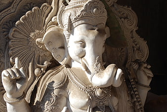 Close-up of ornate white stone Ganesha statue with intricate carvings