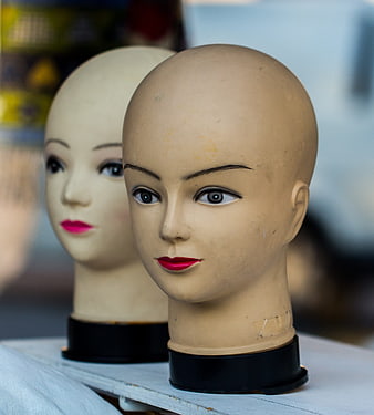 Close-up of vintage mannequin heads with red lipstick
