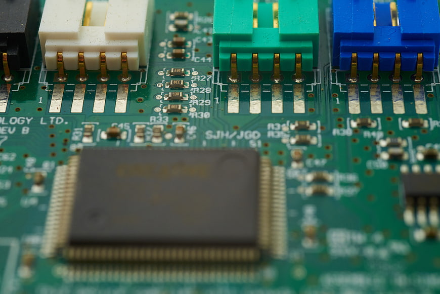 Macro Close-Up of Green Circuit Board with Electronic Components