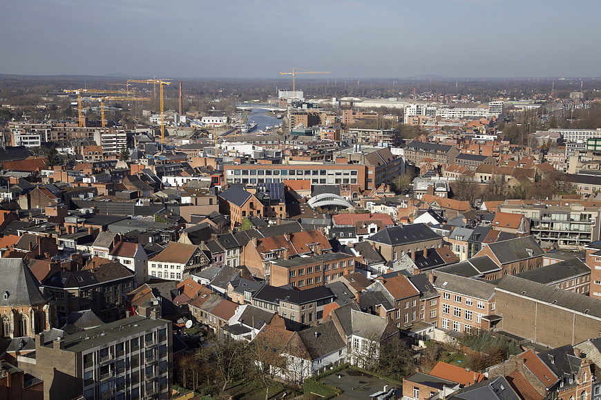 Aerial View of European City with Construction Cranes and Historic Roofs